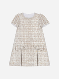 Dress in shiny tweed with bows